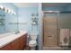Inviting bathroom featuring a shower stall, soft blue walls, and plenty of counter space at 938 Kannapolis Pkwy, Concord, NC 28027