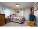 Quaint bedroom with patchwork quilt, warm lighting, and classic furnishings at 938 Kannapolis Pkwy, Concord, NC 28027
