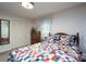 Cozy bedroom featuring a colorful quilt, wood furniture, and a well-lit closet at 938 Kannapolis Pkwy, Concord, NC 28027