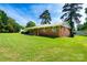 Brick home with a well-kept lawn, mature trees, and a charming curb appeal on a sunny day at 938 Kannapolis Pkwy, Concord, NC 28027