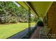 View from the front porch looking out to the lush green lawn and mature trees at 938 Kannapolis Pkwy, Concord, NC 28027
