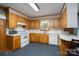 Well-lit kitchen features classic cabinetry, white countertops, and essential appliances for cooking at 938 Kannapolis Pkwy, Concord, NC 28027
