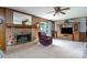 Cozy living room featuring a brick fireplace, wood paneling, and comfortable seating at 938 Kannapolis Pkwy, Concord, NC 28027