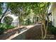 Relaxing backyard features a stone walkway, mature trees, and a pergola-covered patio area at 9644 Marquette Nw St, Concord, NC 28027
