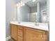 Bathroom featuring a double vanity and frameless shower at 9644 Marquette Nw St, Concord, NC 28027