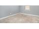 Comfortable bedroom features neutral carpeting, gray walls, and a sunny window at 9644 Marquette Nw St, Concord, NC 28027