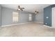 Spacious bedroom with carpet, two windows, and ceiling fans at 9644 Marquette Nw St, Concord, NC 28027