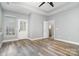 Bright bedroom showcasing a window, an exterior door, and tray ceilings at 9644 Marquette Nw St, Concord, NC 28027