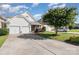 Charming home features a two-car garage, stone accents, and a well-maintained front yard under a bright sky at 9644 Marquette Nw St, Concord, NC 28027