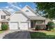Charming home features a two-car garage, stone accents, and a well-maintained front yard and lovely curb appeal at 9644 Marquette Nw St, Concord, NC 28027