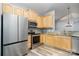 Modern kitchen features stainless steel appliances, granite countertops, and light wood cabinetry at 9644 Marquette Nw St, Concord, NC 28027