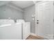 Laundry room featuring washer, dryer, shelving, and a door to the outside at 9644 Marquette Nw St, Concord, NC 28027