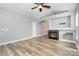 Comfortable living room boasts a fireplace, open layout, wood-look flooring, and abundant natural light at 9644 Marquette Nw St, Concord, NC 28027
