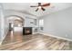 Inviting living room boasts a fireplace, open layout, wood-look flooring, and abundant natural light at 9644 Marquette Nw St, Concord, NC 28027