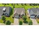 Aerial view of home showcases its well-manicured lawn, landscaping, and a two-car garage with a paved driveway at 1108 Mayapple Way, Belmont, NC 28012