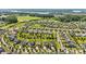 A picturesque aerial view of the neighborhood showcases neatly lined houses, lush landscaping, and water features in the distance at 1108 Mayapple Way, Belmont, NC 28012