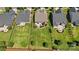 Aerial view of the neighborhood shows well-manicured lawns, landscaping, and a backyard patio with furniture at 1108 Mayapple Way, Belmont, NC 28012