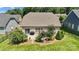 Back exterior featuring sliding glass doors opening to a patio, lush landscaping, and a fenced yard at 1108 Mayapple Way, Belmont, NC 28012