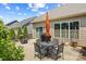 An outdoor patio features an umbrella-covered table, grill, and a fire pit near the back of the house at 1108 Mayapple Way, Belmont, NC 28012