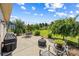 An outdoor living space features a concrete patio with furniture, a grill, and landscaping overlooking a spacious backyard at 1108 Mayapple Way, Belmont, NC 28012