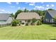 Expansive backyard featuring a lush lawn, mature trees, and a black iron fence at 1108 Mayapple Way, Belmont, NC 28012