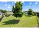 Expansive backyard featuring a lush lawn, mature trees, and a black iron fence at 1108 Mayapple Way, Belmont, NC 28012