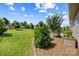 Expansive backyard featuring a lush lawn, mature trees, and a planter box at 1108 Mayapple Way, Belmont, NC 28012