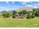 Landscaped backyard with a patio area for outdoor dining and relaxation, and a black iron fence at 1108 Mayapple Way, Belmont, NC 28012