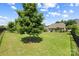 Expansive backyard featuring a lush lawn, mature trees, and a black iron fence at 1108 Mayapple Way, Belmont, NC 28012