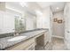 A well-lit main bathroom features a double sink vanity with granite countertop and a glass-enclosed shower at 1108 Mayapple Way, Belmont, NC 28012