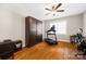 A versatile room is set up for office and exercise; it features wood flooring and a ceiling fan at 1108 Mayapple Way, Belmont, NC 28012