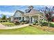 A charming clubhouse with a white facade, inviting porch, and a well-manicured lawn with landscaping at 1108 Mayapple Way, Belmont, NC 28012