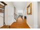 Inviting entryway featuring hardwood floors and staircase leading to a generously lit living room at 1108 Mayapple Way, Belmont, NC 28012