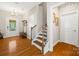 Bright foyer with hardwood floors, staircase and a decorative coat rack at 1108 Mayapple Way, Belmont, NC 28012