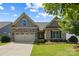 Charming single-story home features a well-manicured lawn, complemented by a two car garage and tasteful landscaping at 1108 Mayapple Way, Belmont, NC 28012