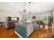 A spacious kitchen flows to a dining area; it features granite countertops, an island, and stainless appliances at 1108 Mayapple Way, Belmont, NC 28012