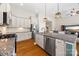 A gourmet kitchen with granite counters, stainless steel appliances, and a tile backsplash offers space and style at 1108 Mayapple Way, Belmont, NC 28012