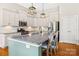 Modern kitchen featuring an island with bar seating, stainless steel appliances, and white cabinets at 1108 Mayapple Way, Belmont, NC 28012