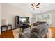Cozy living room with high ceiling, hardwood floors, ceiling fan, and comfortable gray sofas at 1108 Mayapple Way, Belmont, NC 28012