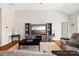 Living room with vaulted ceilings, a decorative wall unit, and hardwood floors at 1108 Mayapple Way, Belmont, NC 28012