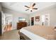 Carpeted main bedroom with ceiling fan, tray ceiling, walk-in closet and en-suite bathroom at 1108 Mayapple Way, Belmont, NC 28012