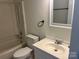 Clean bathroom featuring tub with shower, updated fixtures, toilet and sink at 11123 Harrowfield Rd, Charlotte, NC 28226
