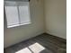Bright bedroom with hardwood-style flooring and ample natural light from the large window at 11123 Harrowfield Rd, Charlotte, NC 28226
