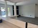Open living space with a modern kitchen, natural light, and a black fireplace at 11123 Harrowfield Rd, Charlotte, NC 28226