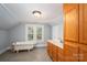 Bathroom features a vintage tub, natural light, and vanity with wood cabinets at 1173 Cat Square Rd, Vale, NC 28168
