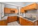 A well-lit kitchen with light wooden cabinets, stainless steel appliances and a double sink at 1173 Cat Square Rd, Vale, NC 28168