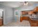 Charming kitchen featuring wooden cabinets, neutral countertops, tile flooring and a modern ceiling fan at 1173 Cat Square Rd, Vale, NC 28168
