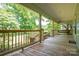 Relaxing front porch with swing and wood railing overlooking the yard at 1173 Cat Square Rd, Vale, NC 28168