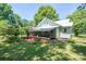 View of the back of the house with covered porch and lush green surroundings at 1173 Cat Square Rd, Vale, NC 28168