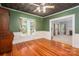 Room with wood floors, desk, green walls, and doorway to living room at 1173 Cat Square Rd, Vale, NC 28168